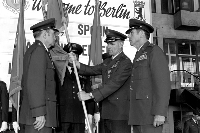 COL Vernon L. Frye, center, relinquishes command of the 7350th Air Base Group, Tempelhof Central Airport, to COL Gary E. Spohn, right.  LGEN Benjamin N. Bellis is to the right.